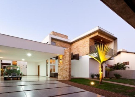 Textured Stone Cladding and Expansive Glass Facades in a Modern Sustainable Residence  