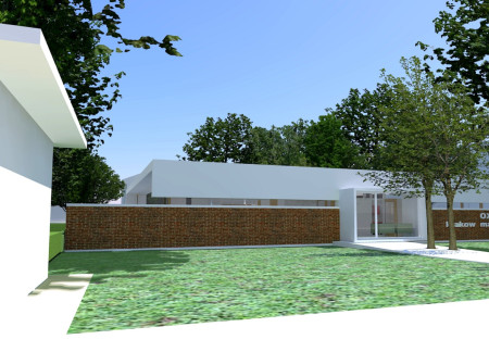 Healthcare facility featuring concrete structure and transparent façades within a natural landscape integration