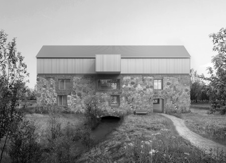 Charred Metal Facade Blending Historical Stonework in a Tranquil Community Retreat