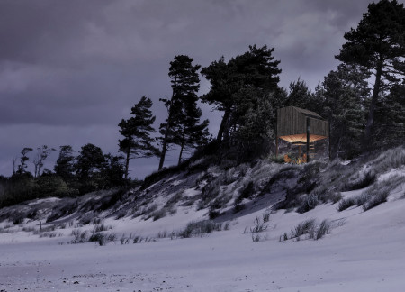 Hiker Shelter Emphasizing Charred Wood Cladding and Elevated Eco-friendly Design