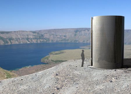 Basalt Structure With Reflective Surfaces Nestled in Volcanic Terrain  