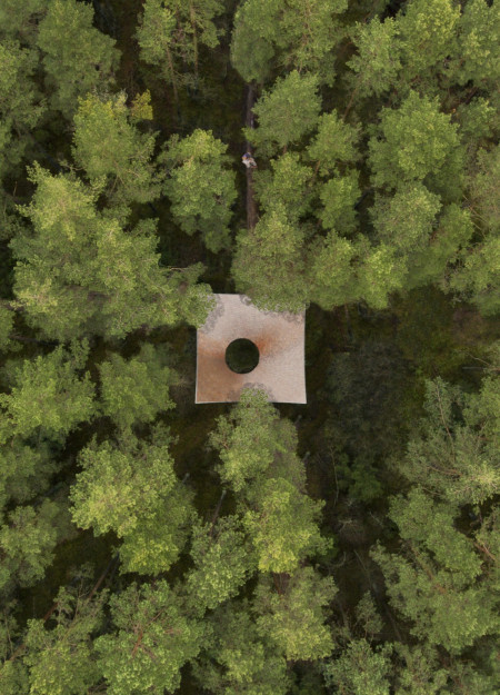 Meditation cabin featuring cross-laminated timber panels and a curvilinear roof design for seamless forest integration