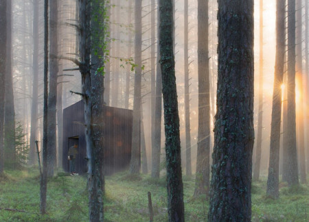Charred Wooden Shingles and Geometric Volumes Create a Sustainable Forest Retreat