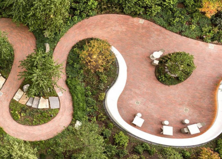 Terracotta Pathways and Natural Stone Seating Foster Serenity in a Sustainable Landscape  