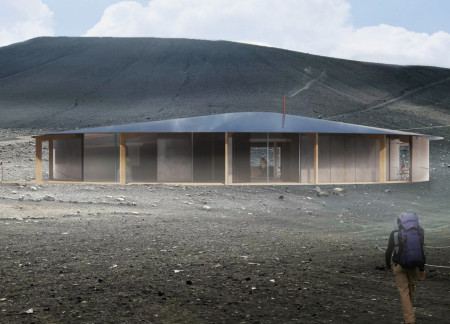 Charred Wooden Shingles and Basalt Countertops Forming a Community Gathering Space Nestled by a Volcanic Landscape