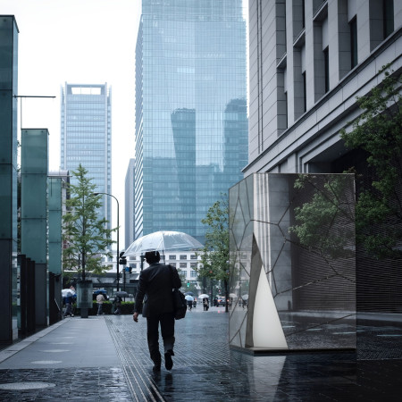 Reflective Cabin With Mirrored Glass and Tapered Form Nestled in Urban Landscape  