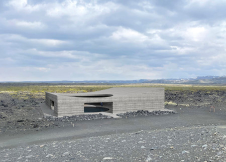 Rammed Earth Structure Embracing Natural Light With Reflective Pools in Volcanic Landscape