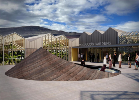 Community greenhouse featuring charred wood cladding and sustainable agricultural practices in a volcanic landscape