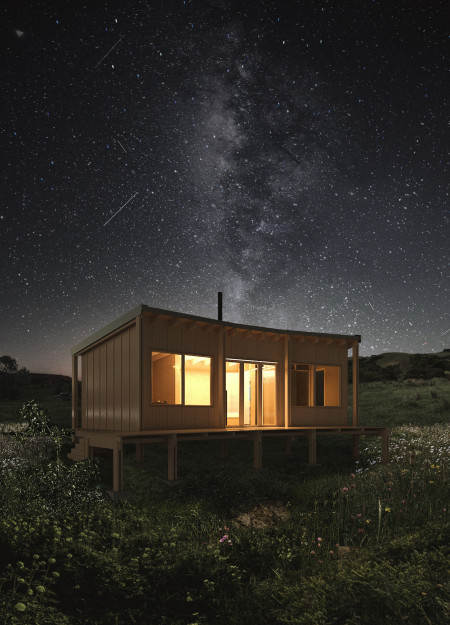 Charred Wooden Shingles Embrace Compact Living in a Nature-Infused Retreat  