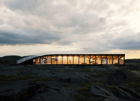 Twisting Form Enveloped in Charred Wood Panels within a Volcanic Landscape Visitor Center  