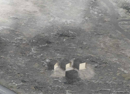 Monolithic Concrete Structure Embracing Natural Light and Secluded Cave Entrances in Icelandic Landscape