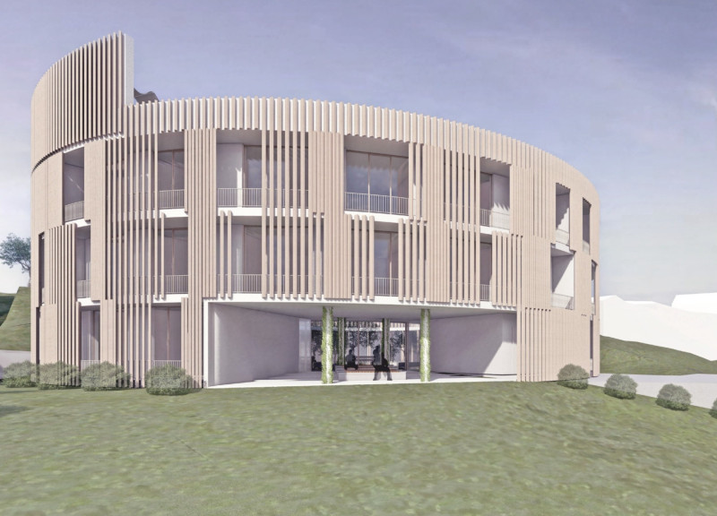 Circular Atrium Surrounded By Vertical Gardens Using Reinforced Concrete And Natural Stone For Enhanced Community Living