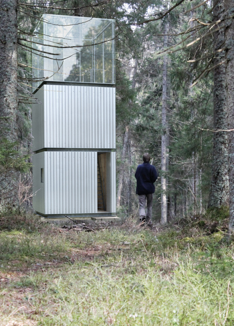 Vertical Retreat Crafted from Corrugated Metal and Plywood Nestled within Nature's Canopy